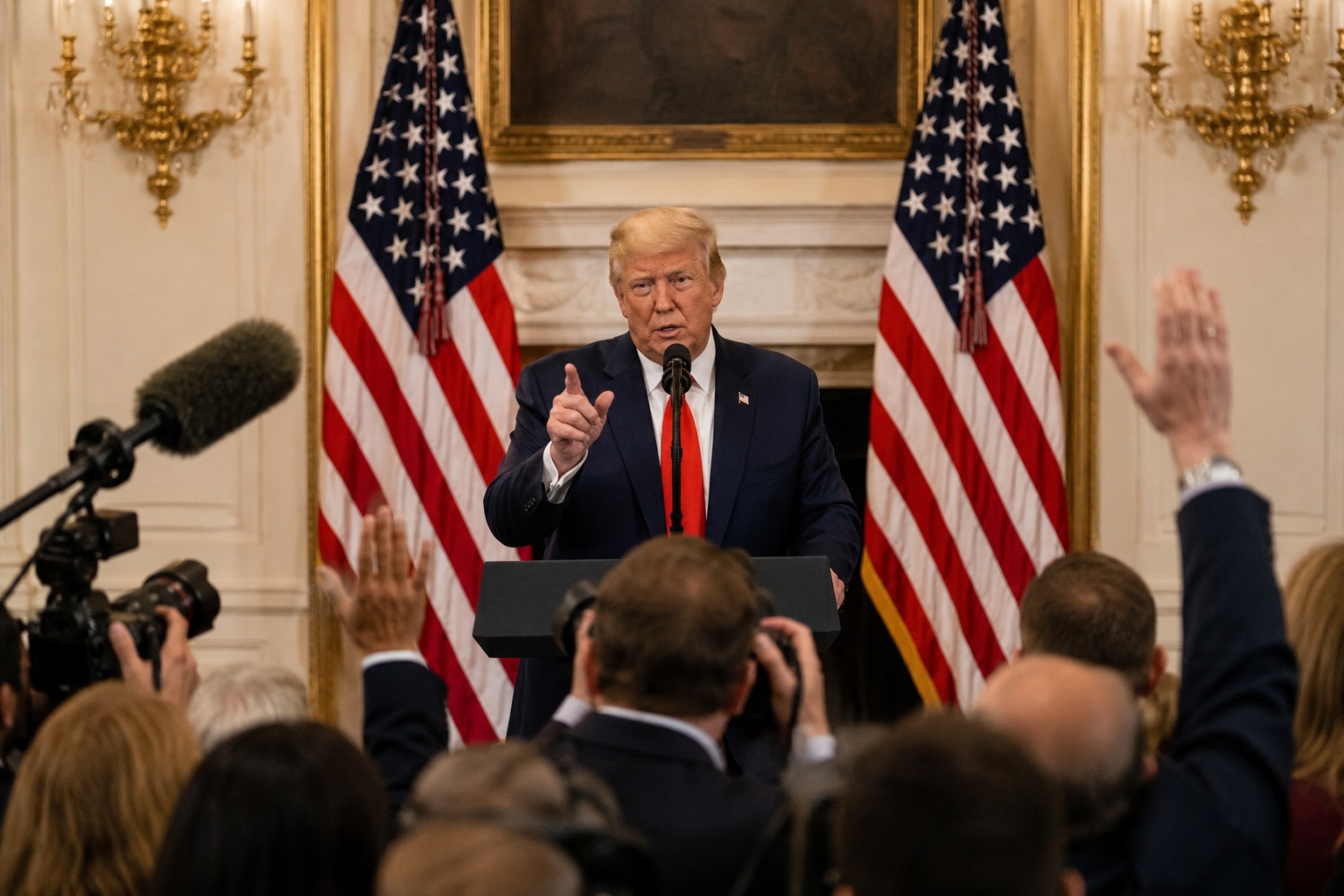 President Donald Trump speaking at a press podium about the economy
